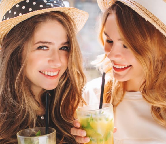 Two young women enjoying some drinks together